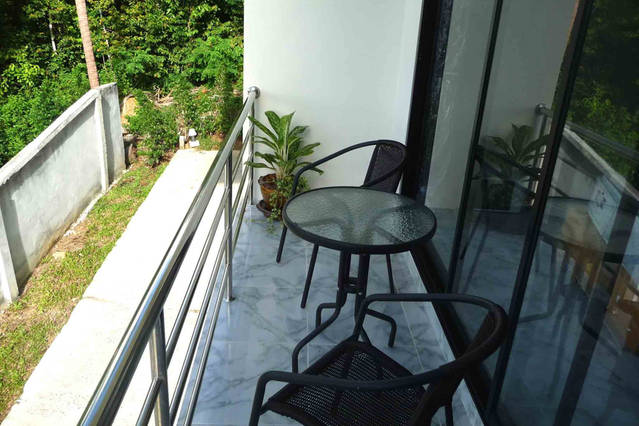 Eden apartment balcony overlooking coconut plantation